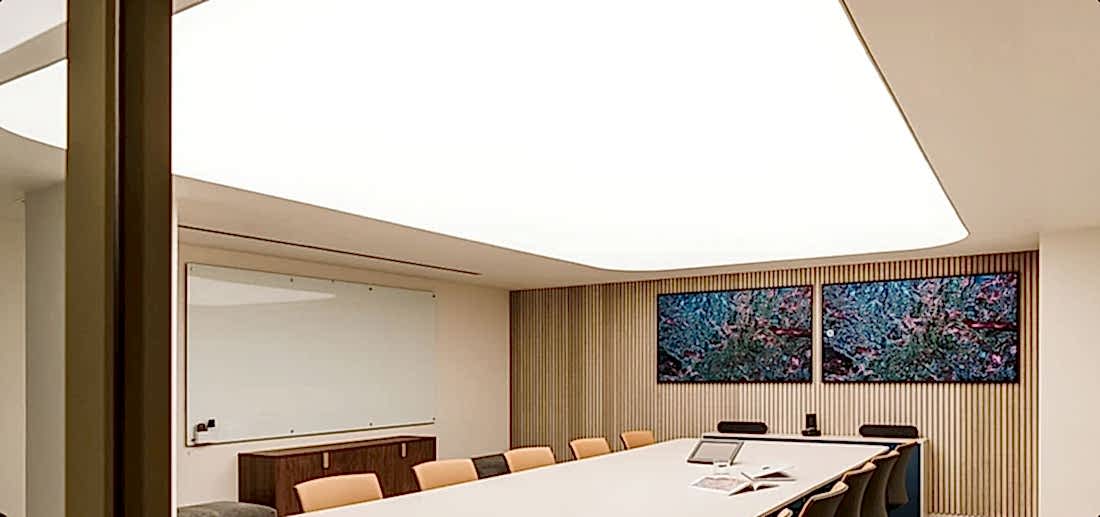 Bright meeting room with illuminated fabric ceilings